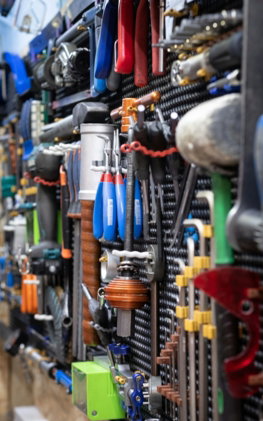 A bunch of tools are hanging on a wall